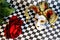 The jester mask carnival and flower red rose Queen of flowers on the background of a chessboard.
