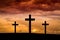 Jesus Christ cross on a red, orange sky with dramatic clouds, dark sunset