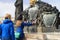 Jesus Christ on Cross statuary group on Charles bridge in Prague with tourists