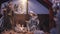 Jesus Christ Nativity scene with figurines in stable and light particles