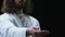 Jesus Christ reaching out his hand against dark background, helping people