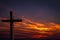 Jesus Christ wooden cross on a background with dramatic, colorful sunset, and orange, purple sky