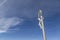 Jesus on the cross against a blue sky with white clouds in the Italian Dolomites on Mount Seceda