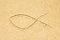 Jesus fish symbol drawing in sand