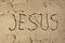 Jesus name in sand