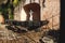 Jesus statue surrounded by candle holders at the Convent de San Bernardino de Siena with grass field in Valladolid, Yucatan,