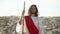 Jesus with wooden staff standing in desert, preaching Christian faith conversion