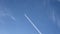 Jet airliner flying high in the sky leaves contrails in the clear blue sky