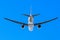 Jet airliner flying under blue sky