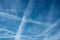 Jet airplane  contrails crossings in blue sky
