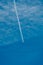 Jet airplane flying in a blue sky forming white contrails
