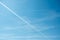 Jet plane contrails. Aircraft routes on blue sky. White airways traces. Long lasting condensation trails, chemtrails