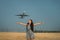 Jet plane takes off on the background behind a young woman