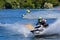 Jet Ski  race competitor cornering at speed creating at lot of spray.