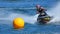 Jet Ski  race competitor cornering at speed creating at lot of spray.