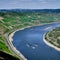 Jet ski\\\'s speed around a curve in the Rhine River as seen from a nearby mountain top