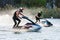 Jet ski superjet racers drive watercrafts splashing in sunset while racing at South Russian
