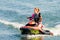 Jet ski watercraft beautiful Caucasian woman driver driving water bike on summer sunny day