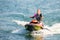 Jet ski watercraft beautiful Caucasian woman driver driving water bike on summer sunny day