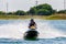 Jet ski watercraft driver in helmet in action on summer sunny day
