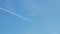 jet stream of airplane going in blue sky