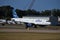 Jetblue white plane with colorful empennage taxiing to the runway at T.F. Green Airport