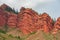 Jeti-Ã–gÃ¼z Rocks In Kyrgyzstan. Jety-Oguz gorge Canyon, cliffs of seven bulls. Red rocks, erosion in clay, cloudy sky and steppe