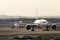 Jets lined up at a busy airport