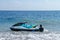 Jetski floating on blue sea water. Strong power watercraft is waiting customers. Young Indonesian holding a jetbike near the shore