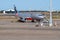 Jetstar Airbus A320 airliner refuelling on tarmac at Brisbane airport with front stairs in place ready for boarding