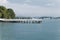 Jetty in coast on blue sky background.