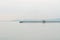 Jetty fishing boat over seacoast skyline