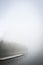 Jetty in foggy water landscape