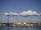 Jetty full of moored sailing yachts in a row during summer vacation season with beautiful waterscape background