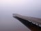 Jetty at a lake in foggy morning