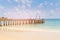 Jetty over sand beach blue skyline