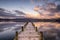 Jetty over Windermere lake with early morning sunlight