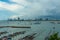 Jetty at Pattaya bay with blue sky and gray clouds covered