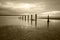 Jetty pier remains on a beach.