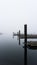 Jetty post and boating docks on a misty morning