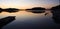 A jetty reflected in the still water at sunset, reflection on water