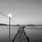 Jetty on sea at dawn. Black and white