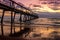 Jetty at The Spit, Queensland at sunrise with seagull in the foreground.