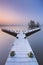 Jetty on a still lake on a foggy winter\'s morning