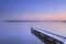 Jetty on a still lake in winter in The Netherlands