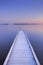 Jetty on a still lake in winter in The Netherlands