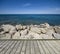 Jetty with stony coast of sea