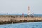 Jetty with towers and buoys. Beautiful seascape, copy space. Breakwater for protect ships at shipyard from waves