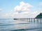 Jetty wooden bridge into blue sea and sky. Pier over water. Vacation And tourism concept. Tropical resort. Jetty on Koh Kood