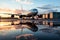 The jetway and a passenger aircraft\\\'s reflection in a serene puddle scene